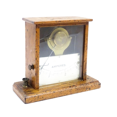 1204 - An early 20thC amperes / amp meter within a glazed case. Approx. 6 3/4