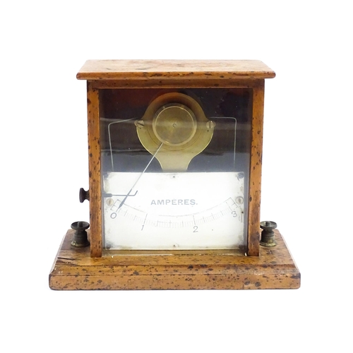 1204 - An early 20thC amperes / amp meter within a glazed case. Approx. 6 3/4