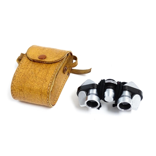 1206 - A cased pair of mid-to-late 20thC Plum 6x15 pocket binoculars, serial number 14960, approx 3 3/4