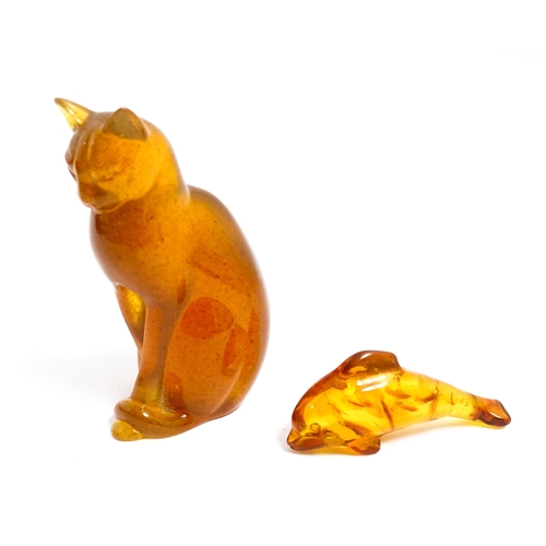 1210 - A 20thC carved amber model of a seated cat, indistinctly signed under. Together with an amber model ... 