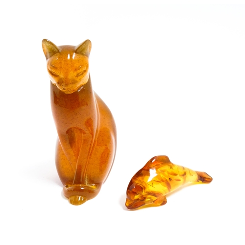 1210 - A 20thC carved amber model of a seated cat, indistinctly signed under. Together with an amber model ... 