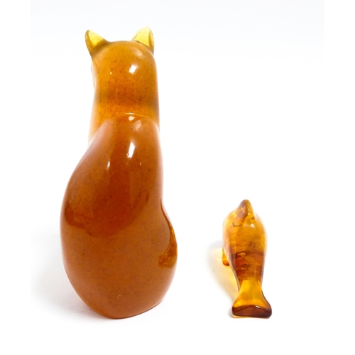 1210 - A 20thC carved amber model of a seated cat, indistinctly signed under. Together with an amber model ... 