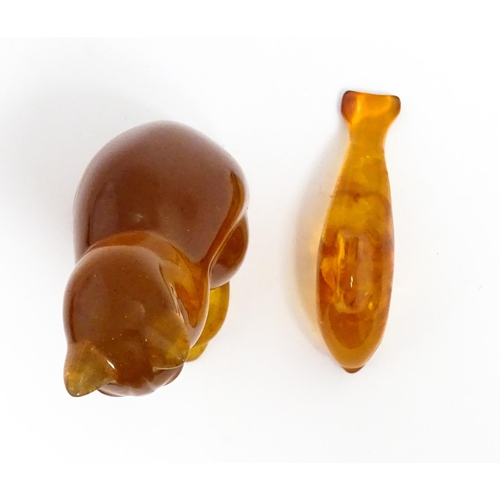 1210 - A 20thC carved amber model of a seated cat, indistinctly signed under. Together with an amber model ... 