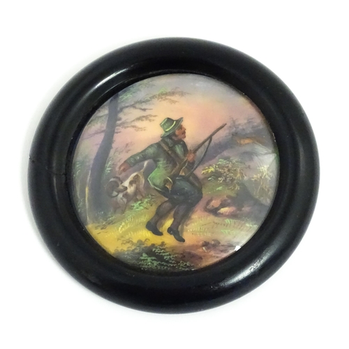 1217 - An early 20thC hand painted porcelain plaque of circular form depicting a wooded landscape with a hu... 