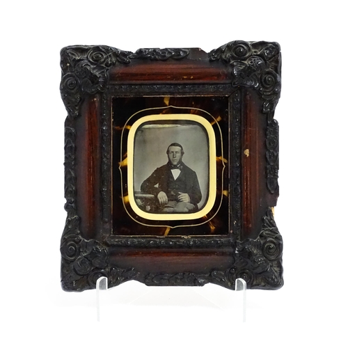 1218 - A Victorian ambrotype photograph depicting a portrait of a seated gentleman within a faux tortoisesh... 