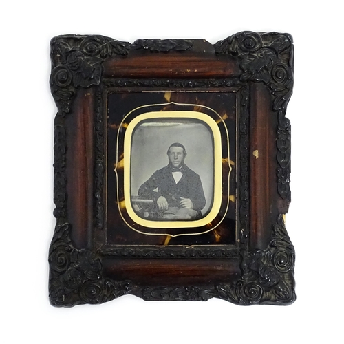 1218 - A Victorian ambrotype photograph depicting a portrait of a seated gentleman within a faux tortoisesh... 