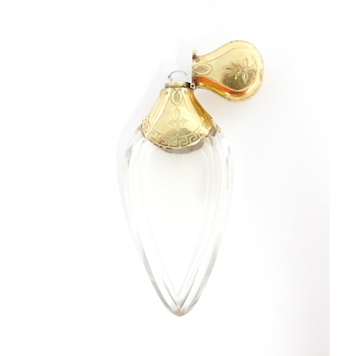 1229 - A 19thC glass scent bottle of teardrop form with Continental silver gilt mounts and hinged lid with ... 