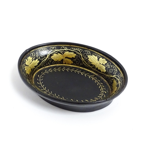 1233 - A 19thC lacquered papier mache pin dish of oval form with gilt scrolling vine decoration. Approx. 4 ... 