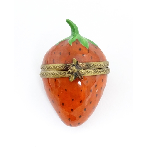 1235 - A Limoges pill box modelled as a strawberry with hinged lid, gilt mounts and insect clasp. Marked wi... 