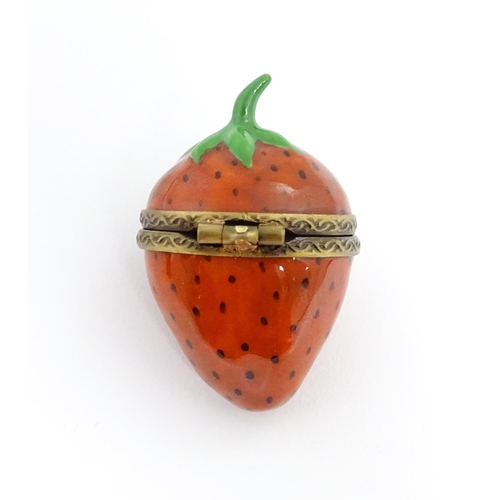 1235 - A Limoges pill box modelled as a strawberry with hinged lid, gilt mounts and insect clasp. Marked wi... 