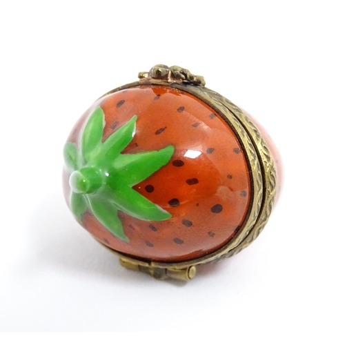 1235 - A Limoges pill box modelled as a strawberry with hinged lid, gilt mounts and insect clasp. Marked wi... 