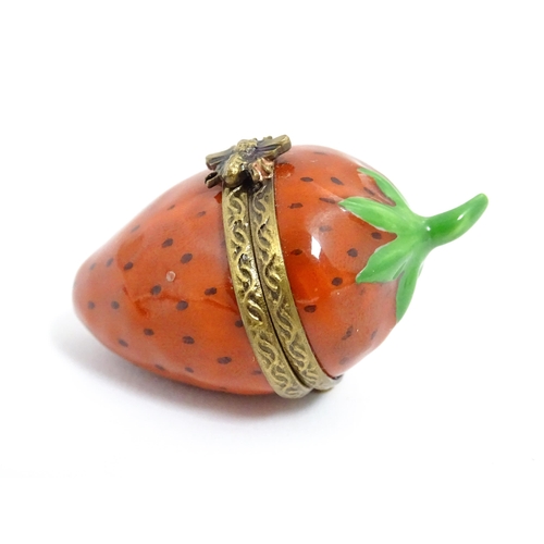 1235 - A Limoges pill box modelled as a strawberry with hinged lid, gilt mounts and insect clasp. Marked wi... 