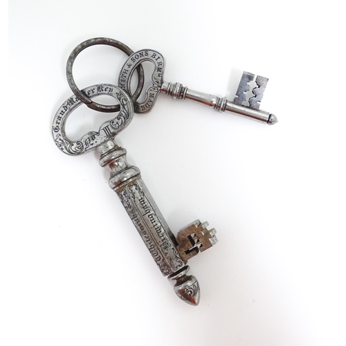 1237 - Two late 19th / early 20thC advertising keys by C. Smith & Sons the larger with engraved foliate dec... 