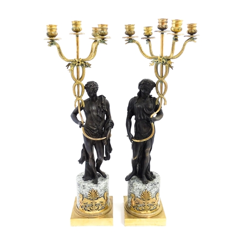 1257 - A pair of late 19th / early 20thC candelabras / candelabrum with cast bronze Classical figures suppo... 