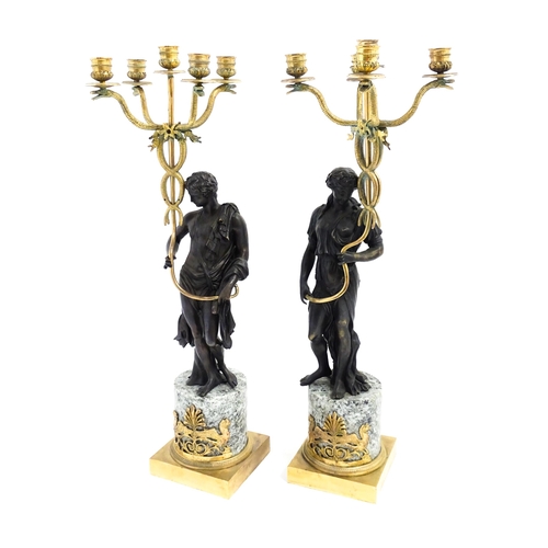 1257 - A pair of late 19th / early 20thC candelabras / candelabrum with cast bronze Classical figures suppo... 