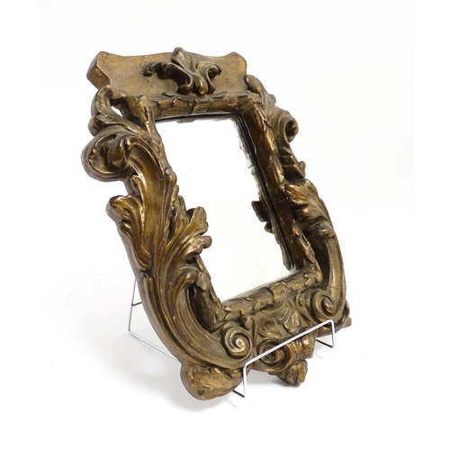 1258 - A late 19th / early 20thC carved giltwood and gesso framed mirror with acanthus leaf and scroll deco... 