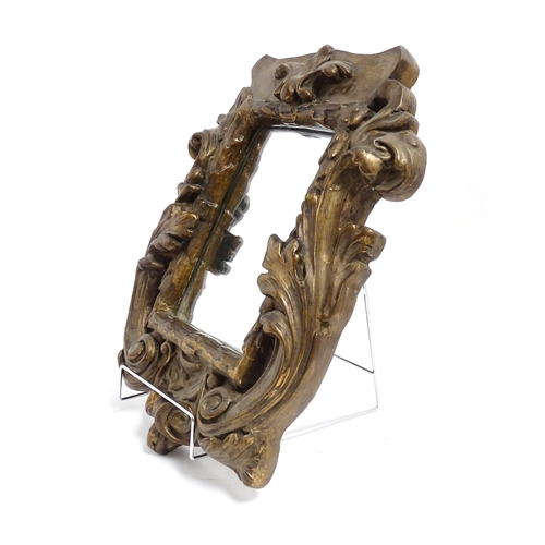 1258 - A late 19th / early 20thC carved giltwood and gesso framed mirror with acanthus leaf and scroll deco... 