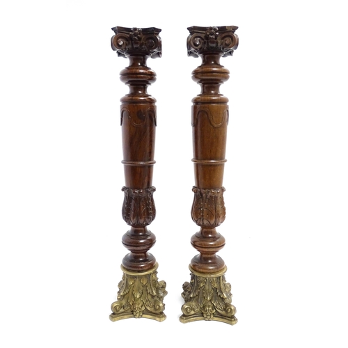 1263 - A pair of large 20thC turned rosewood candlesticks of column form with acanthus scroll decoration an... 