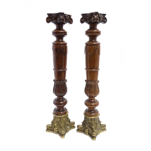 1263 - A pair of large 20thC turned rosewood candlesticks of column form with acanthus scroll decoration an... 