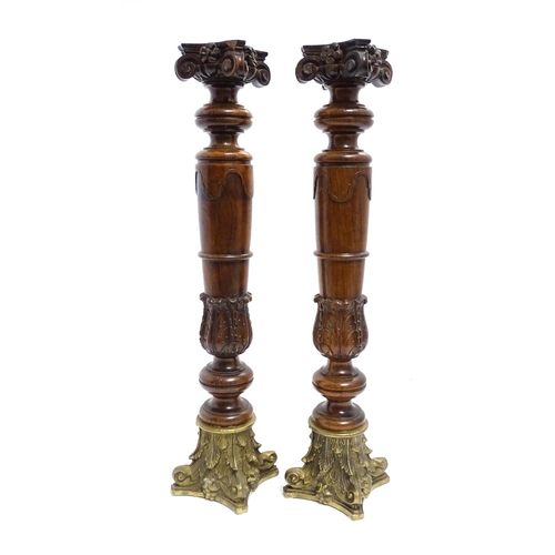 1263 - A pair of large 20thC turned rosewood candlesticks of column form with acanthus scroll decoration an... 