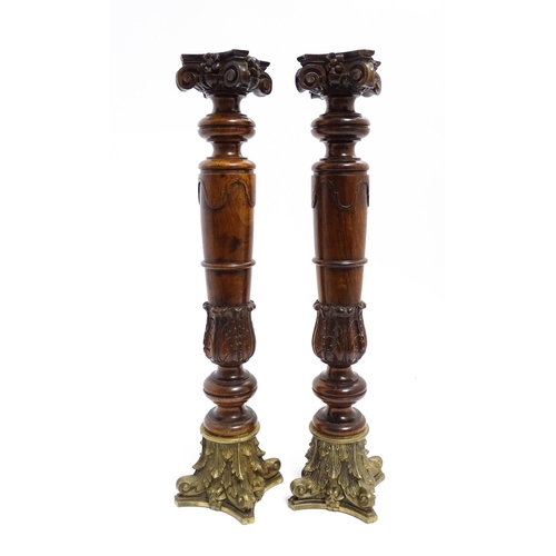 1263 - A pair of large 20thC turned rosewood candlesticks of column form with acanthus scroll decoration an... 