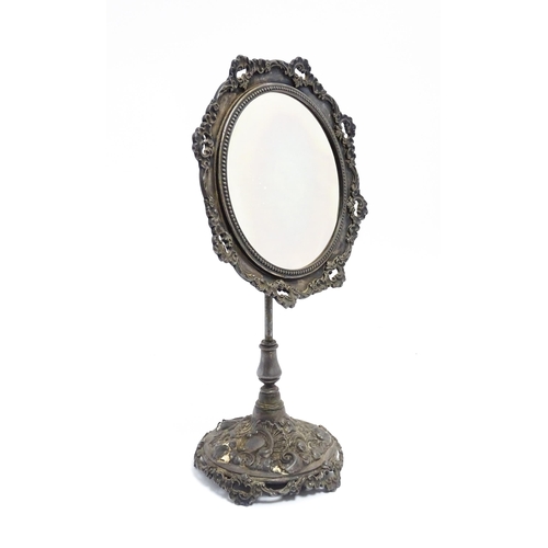 1264 - A 20thC cast vanity magnifying mirror with scrolling floral and foliate decoration. Approx. 19