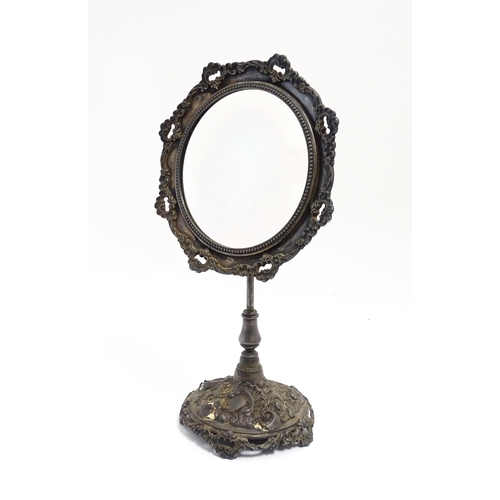 1264 - A 20thC cast vanity magnifying mirror with scrolling floral and foliate decoration. Approx. 19