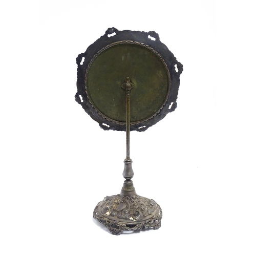 1264 - A 20thC cast vanity magnifying mirror with scrolling floral and foliate decoration. Approx. 19