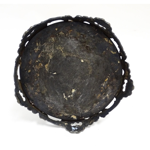 1264 - A 20thC cast vanity magnifying mirror with scrolling floral and foliate decoration. Approx. 19