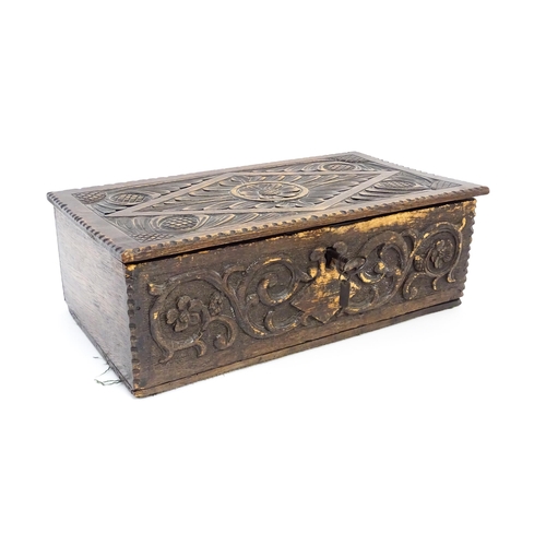 1271 - A 19thC oak bible box with carved floral and scrolling foliate detail. Approx. 5 3/4