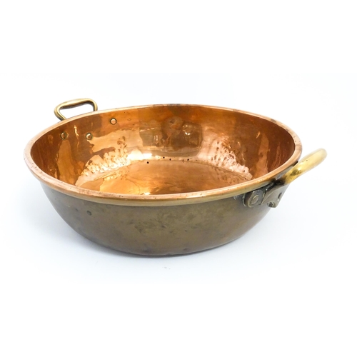 1278 - A large Victorian twin handled copper bowl. Together with three graduated pans one stamped Jones Bro... 