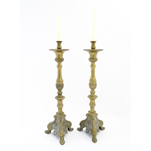 1283 - A pair of large 19thC cast brass ecclesiastical / altar candlesticks with lion paw feet and angel he... 