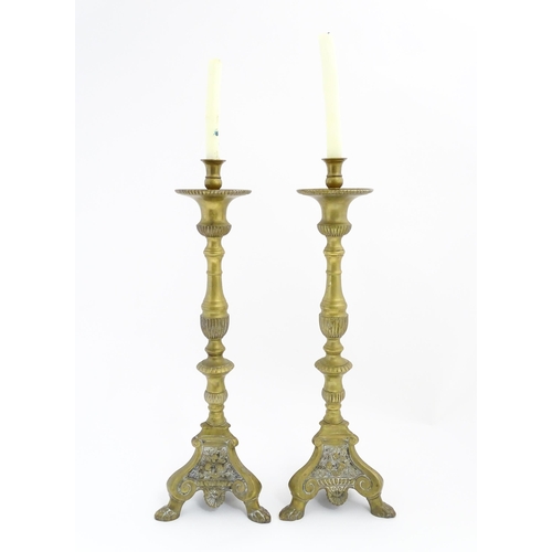 1283 - A pair of large 19thC cast brass ecclesiastical / altar candlesticks with lion paw feet and angel he... 