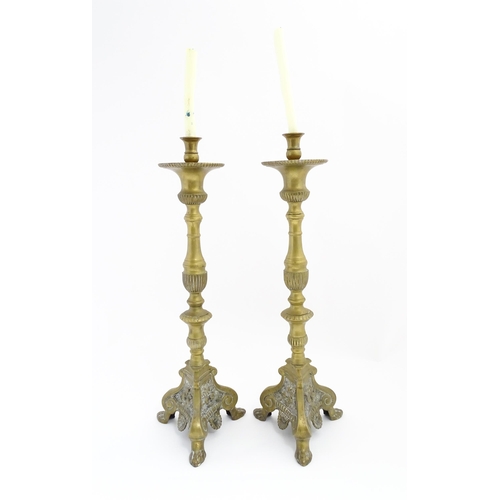 1283 - A pair of large 19thC cast brass ecclesiastical / altar candlesticks with lion paw feet and angel he... 