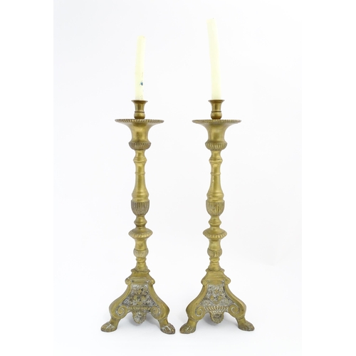 1283 - A pair of large 19thC cast brass ecclesiastical / altar candlesticks with lion paw feet and angel he... 