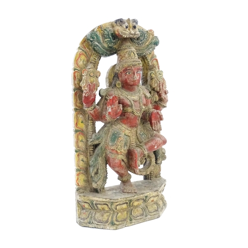 1289 - An Indian carved wooden model of a Hindu deity with gesso and polychrome decoration. Approx. 22 1/4