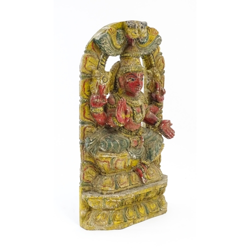 1290 - An Indian carved wooden model of a Hindu deity with gesso and polychrome decoration. Approx. 18