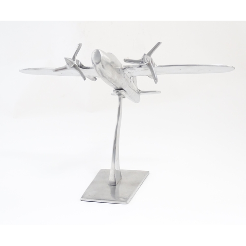 1292 - An Art Deco style cast model of a twin engine propeller aeroplane. Approx 10 1/8