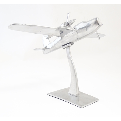 1292 - An Art Deco style cast model of a twin engine propeller aeroplane. Approx 10 1/8