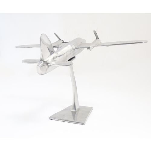 1292 - An Art Deco style cast model of a twin engine propeller aeroplane. Approx 10 1/8