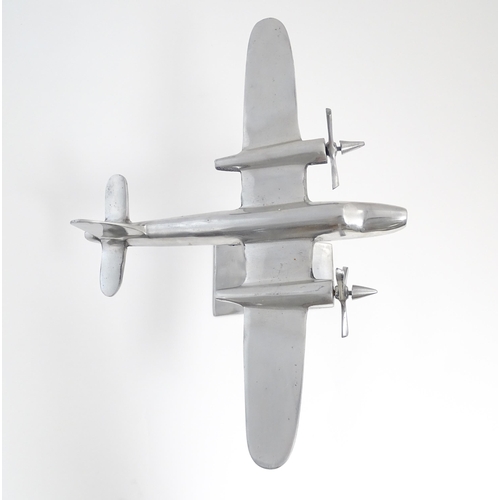 1292 - An Art Deco style cast model of a twin engine propeller aeroplane. Approx 10 1/8