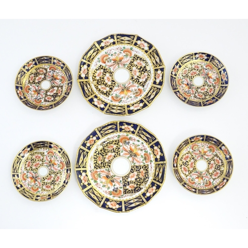 146 - A quantity of Derby tea wares decorated in the Imari pattern to include cups, saucers, plates, etc. ... 