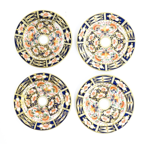 146 - A quantity of Derby tea wares decorated in the Imari pattern to include cups, saucers, plates, etc. ... 