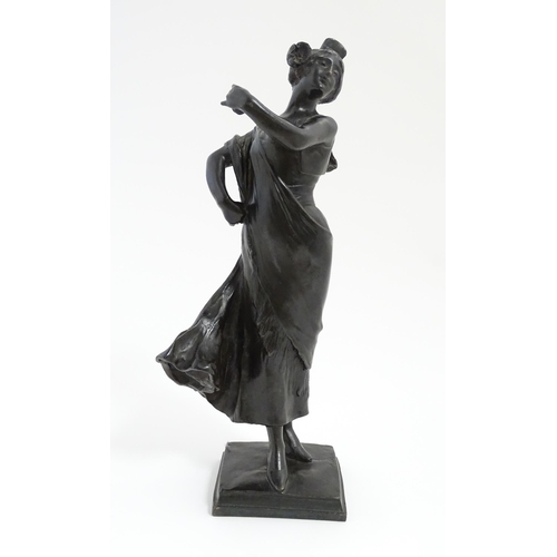 1032 - An Art Nouveau cast bronze figure modelled as a lady dancing with a flower in her hair. Indistinctly... 