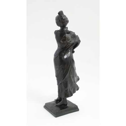 1032 - An Art Nouveau cast bronze figure modelled as a lady dancing with a flower in her hair. Indistinctly... 