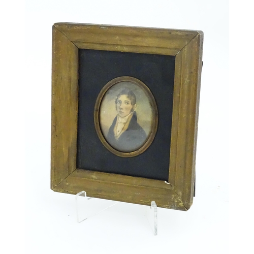 1212 - A 19thC watercolour on card portrait miniature depicting a young man wearing a blue jacket. Indistin... 