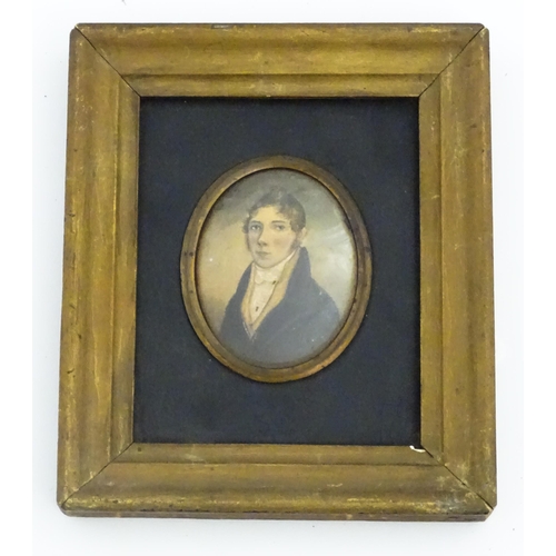 1212 - A 19thC watercolour on card portrait miniature depicting a young man wearing a blue jacket. Indistin... 