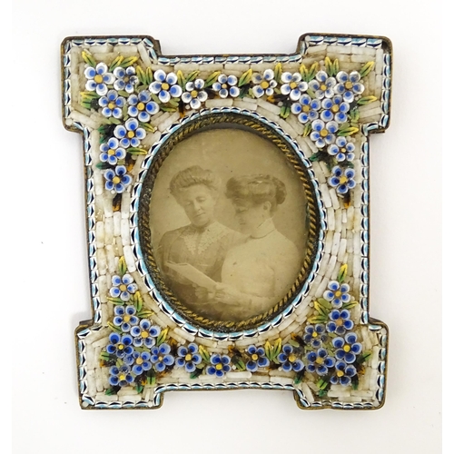 1219 - An early 20thC photograph frame with floral micro mosaic surround. Together with an oval porcelain p... 