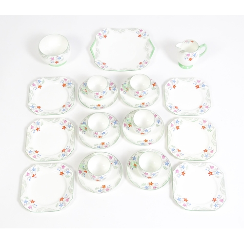 197 - A quantity of Shelley tea wares decorated with flowers to include cups, saucers, plates, cake / sand... 