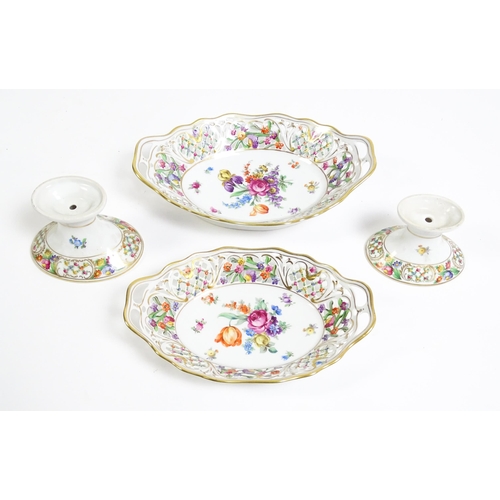 91 - A German part dessert service with pierced borders and floral decoration, to include plates, basket,... 